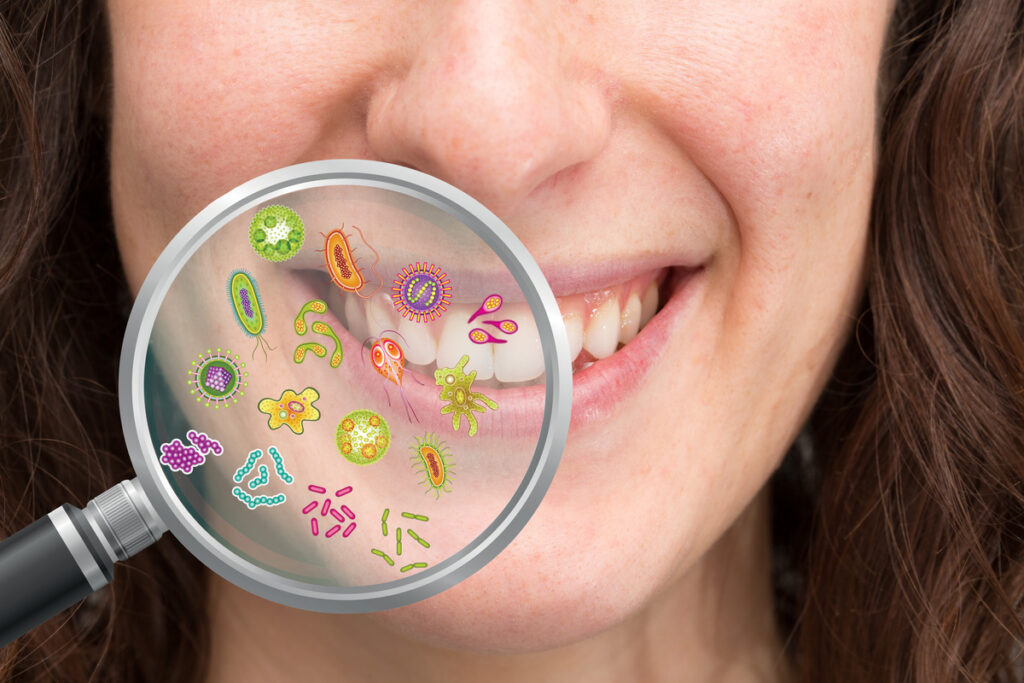 Magnifying glass showing possible set of bacteria the oral cavity causing caries, plaque, tartar, gingivitis, pyorrhea and halitosis