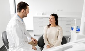 Dentist discussing gum and heart health with a patient at Dental Associates of Jersey City
