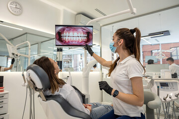 Dentist examining a patient's teeth during a checkup related to sleep apnea and oral health